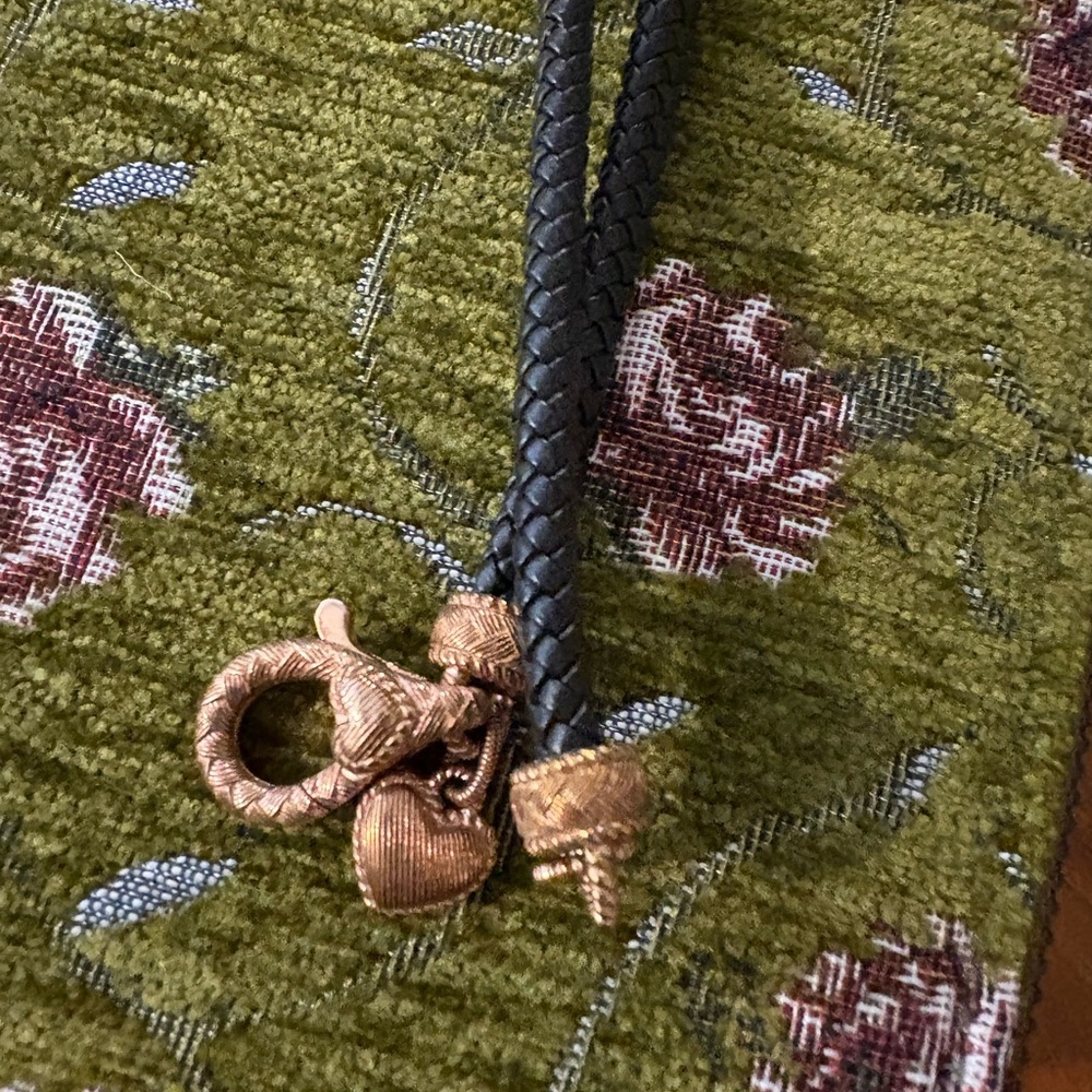 Judith Ripka. Braided necklace with rose gold over silver caps with a heart